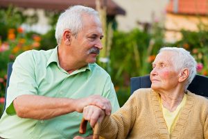 adult son caring for senior mother with dementia